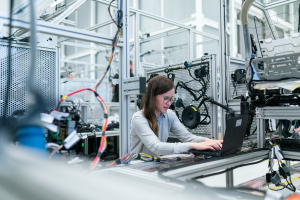 Woman on computer in factory